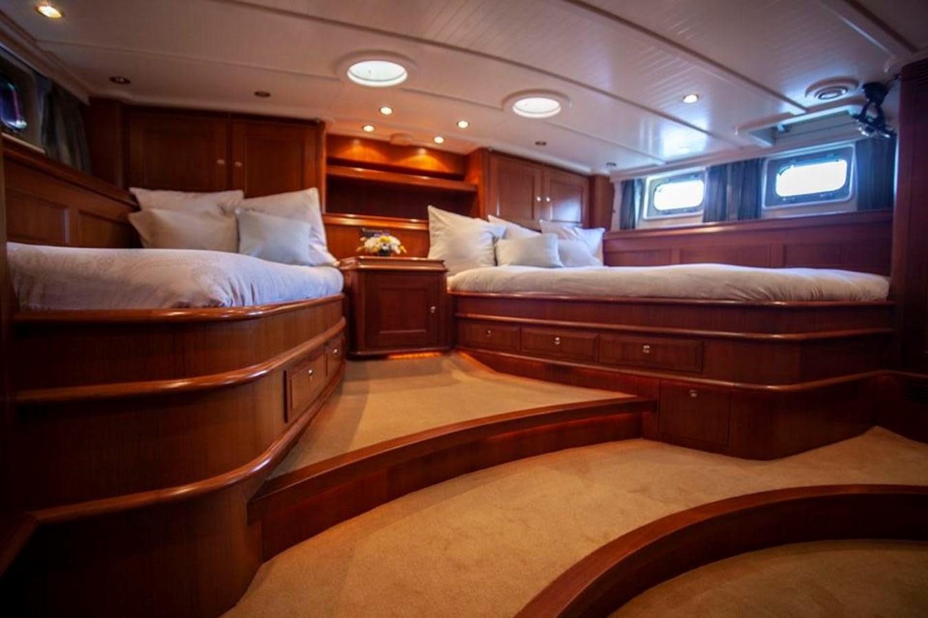 a room with a bed and a desk aboard SWEET EMOTION Yacht for Sale