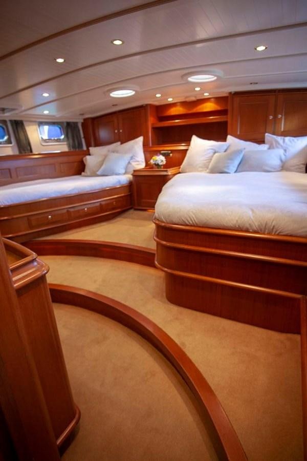 a room with beds and a wood floor aboard SWEET EMOTION Yacht for Sale