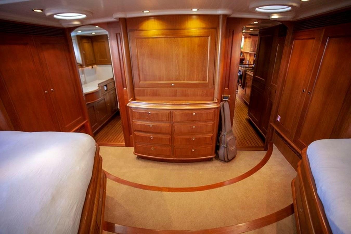 a room with a wood cabinet and a chair aboard SWEET EMOTION Yacht for Sale