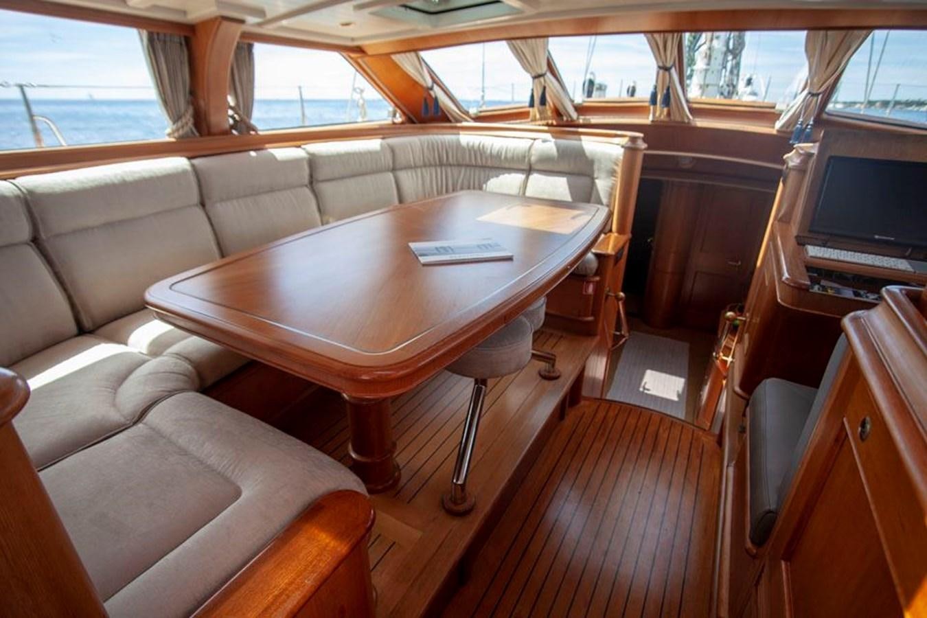 a wooden table in a boat aboard SWEET EMOTION Yacht for Sale