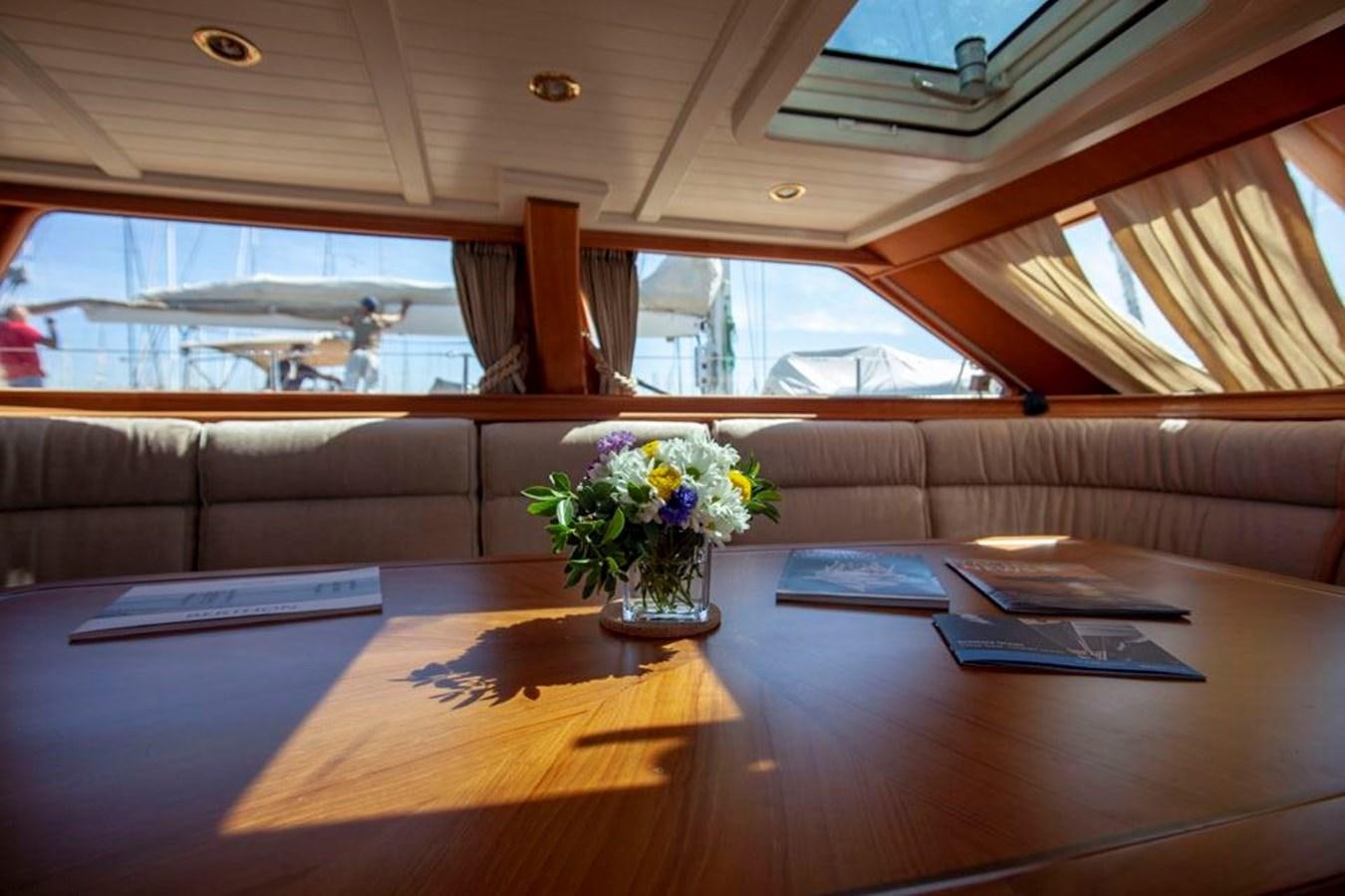 a table with books and flowers aboard SWEET EMOTION Yacht for Sale