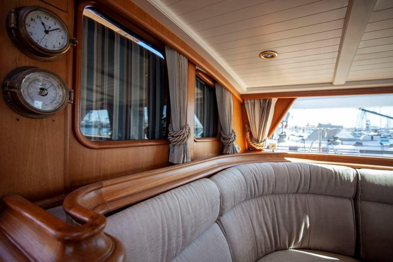 a couch with a clock on it aboard SWEET EMOTION Yacht for Sale