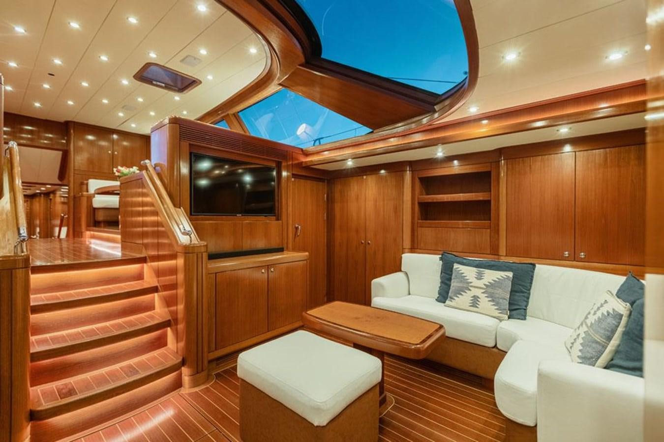 a room with a couch and a television aboard PAULINE AF SKANOR Yacht for Sale