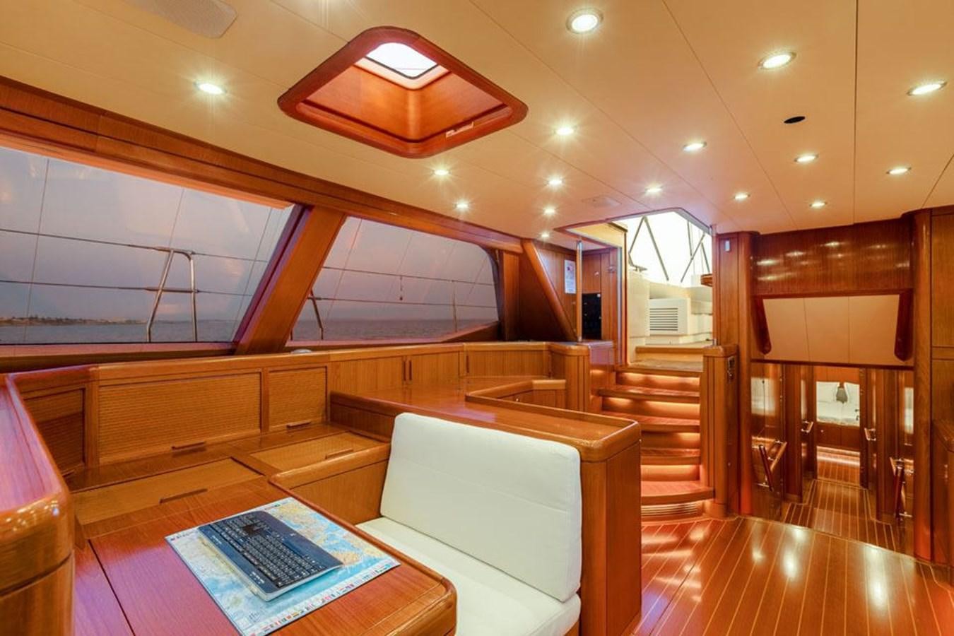 a room with a large wood staircase aboard PAULINE AF SKANOR Yacht for Sale
