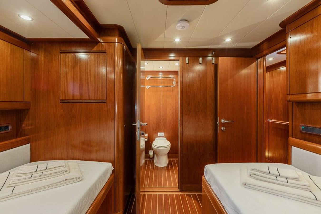 a bathroom with wooden cabinets aboard PAULINE AF SKANOR Yacht for Sale