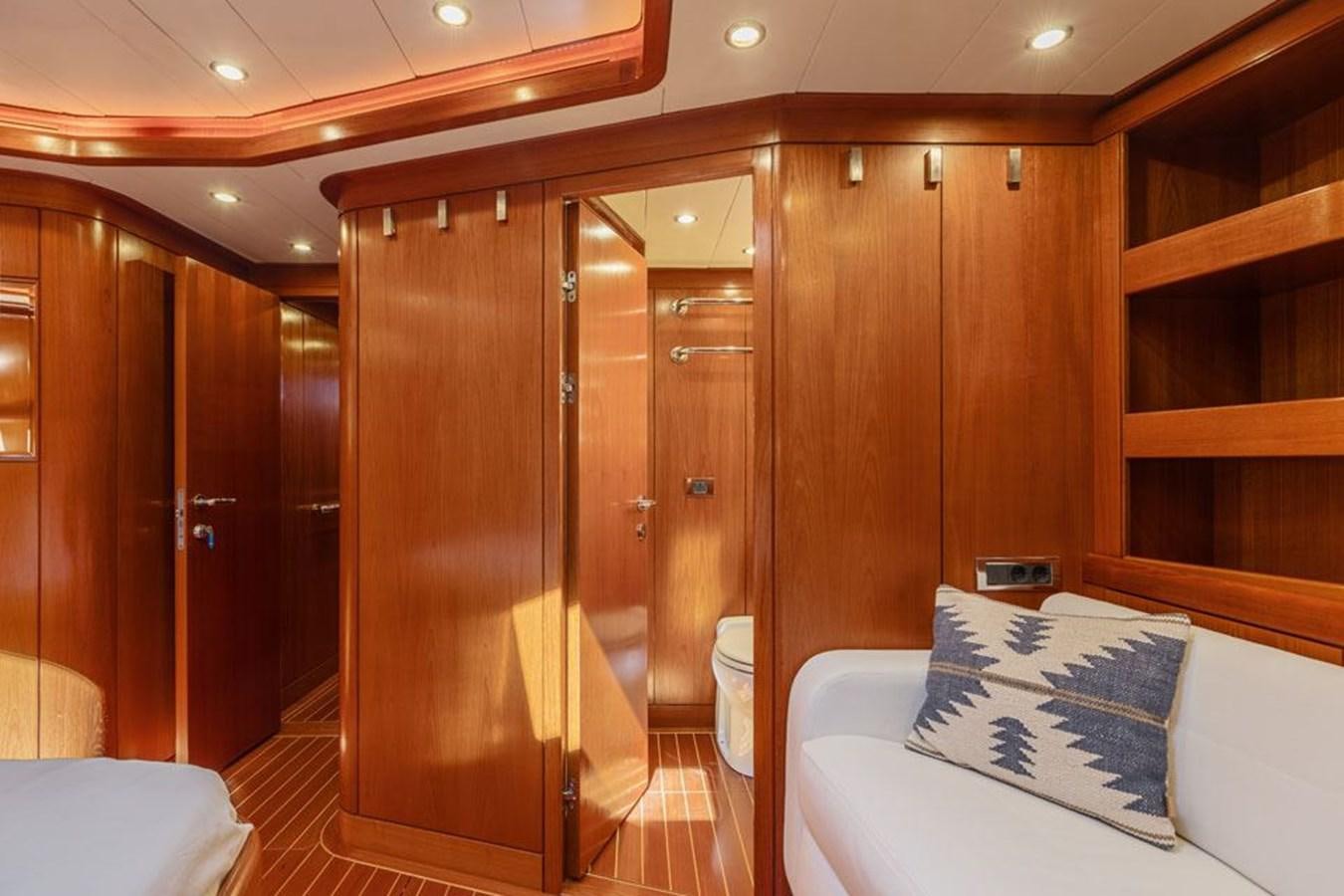 a room with a bed and a closet aboard PAULINE AF SKANOR Yacht for Sale