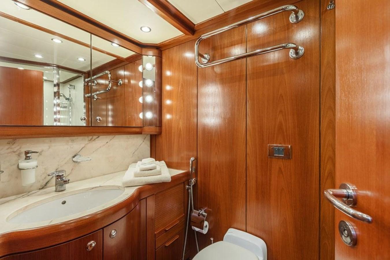 a bathroom with wooden cabinets aboard PAULINE AF SKANOR Yacht for Sale