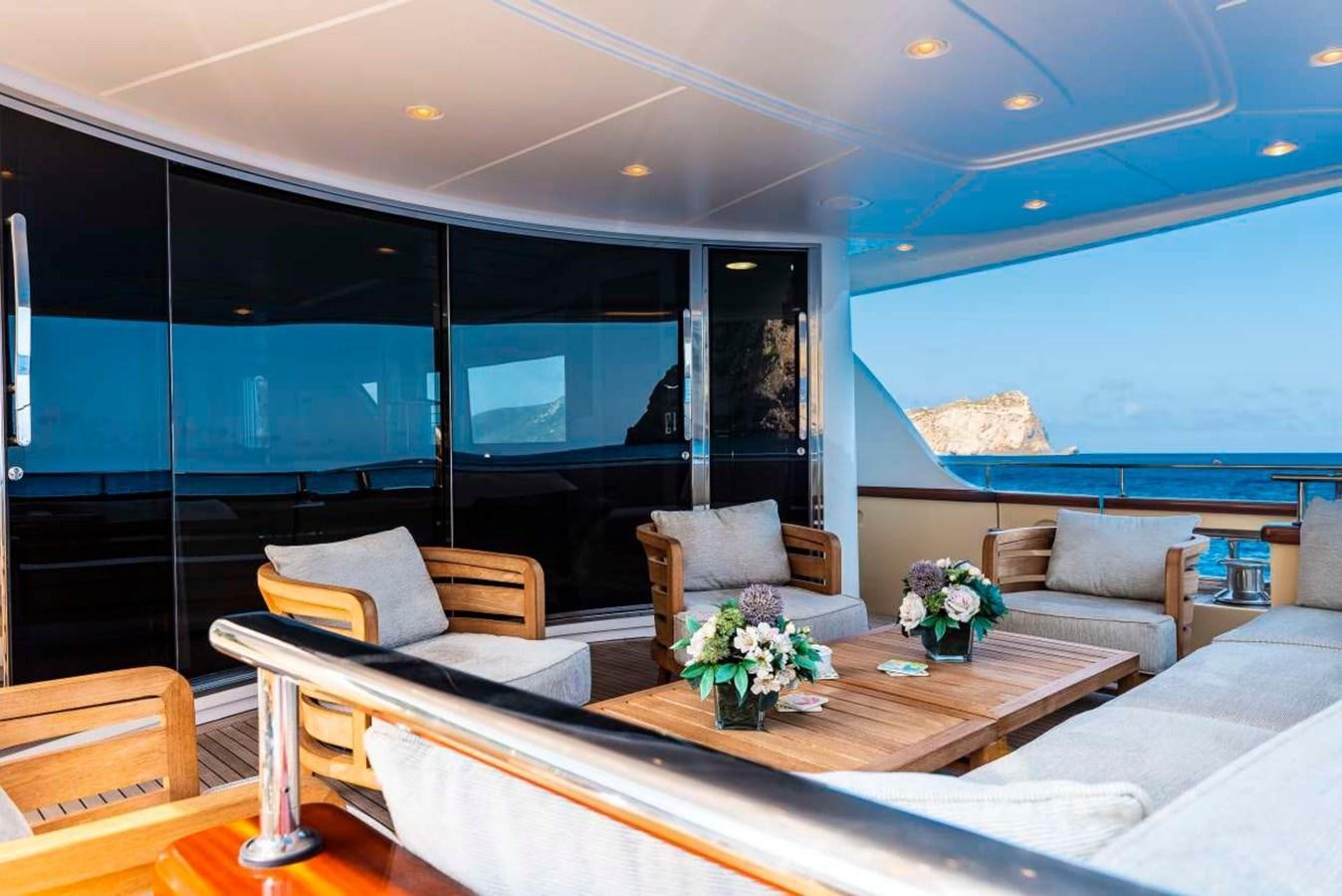 a living room with a large window aboard CHRISTINA Yacht for Sale