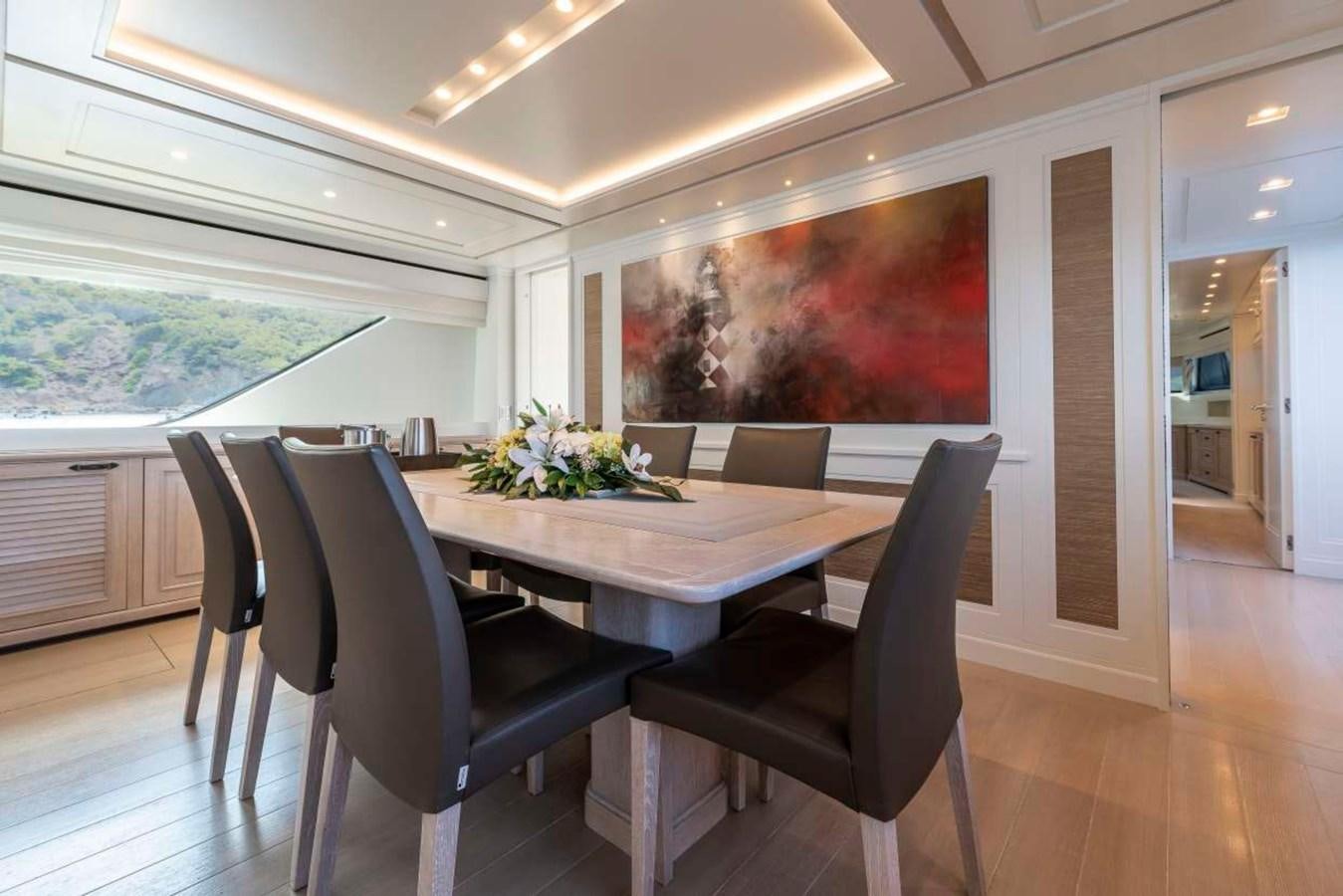 a table and chairs in a room aboard CHRISTINA Yacht for Sale