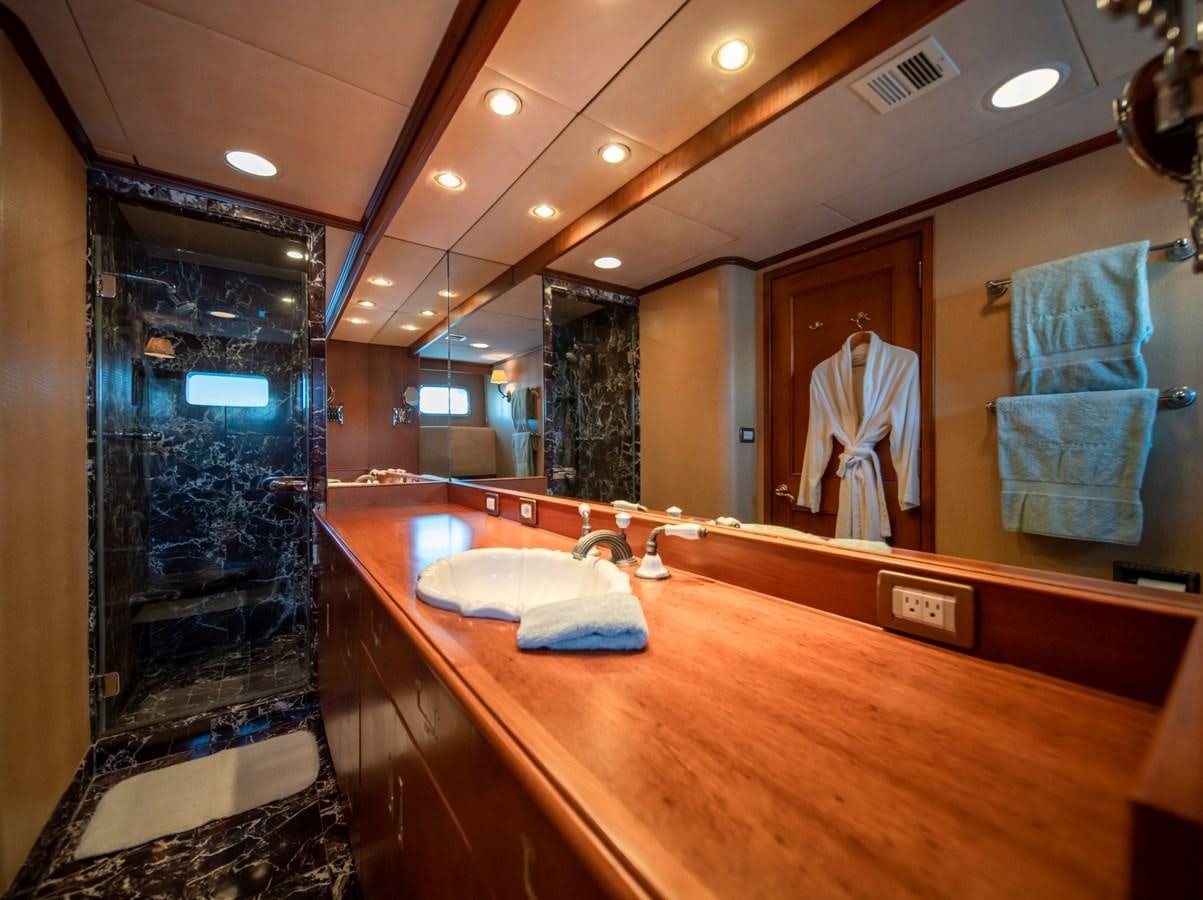 a bathroom with a countertop sink and a mirror aboard SEA FALCON II Yacht for Sale