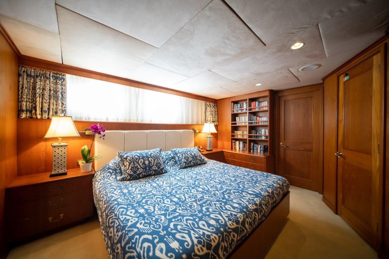 a bedroom with a bed and a desk aboard SEA FALCON II Yacht for Sale
