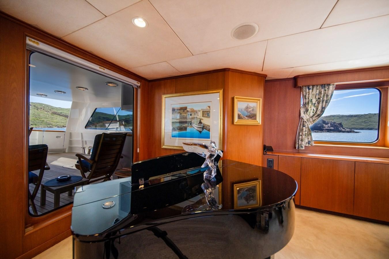 a room with a piano and a piano aboard SEA FALCON II Yacht for Sale