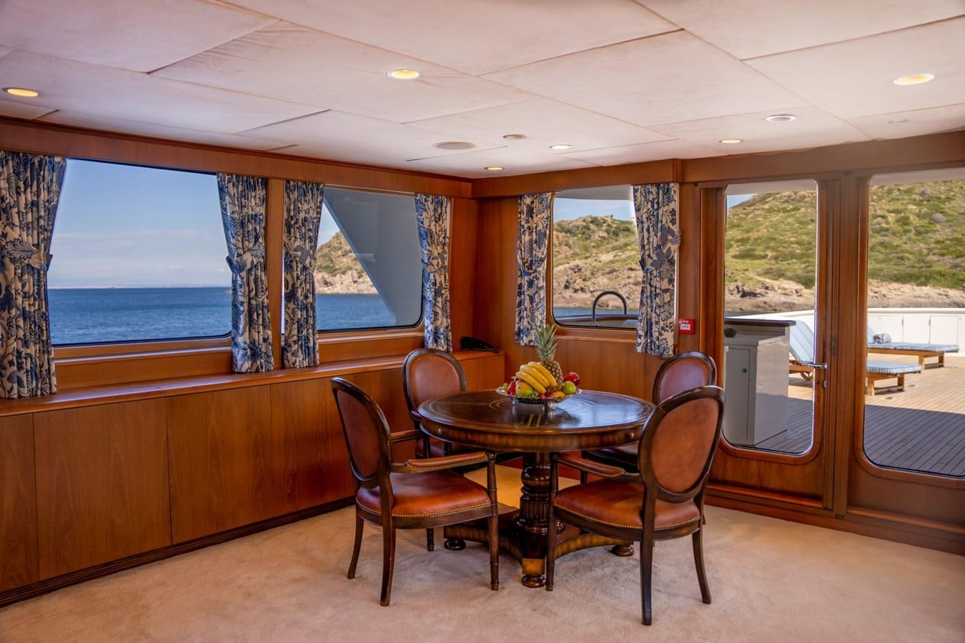 a table and chairs in a room aboard SEA FALCON II Yacht for Sale