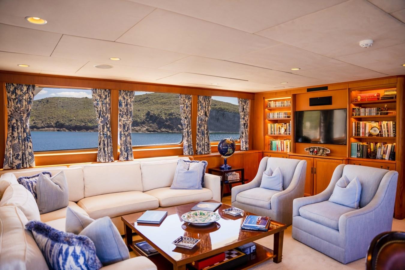 a living room with a large window aboard SEA FALCON II Yacht for Sale