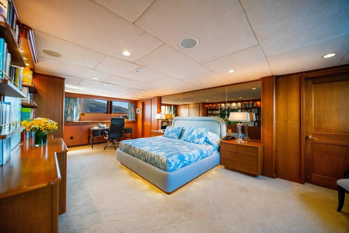 a bedroom with a blue couch aboard SEA FALCON II Yacht for Sale
