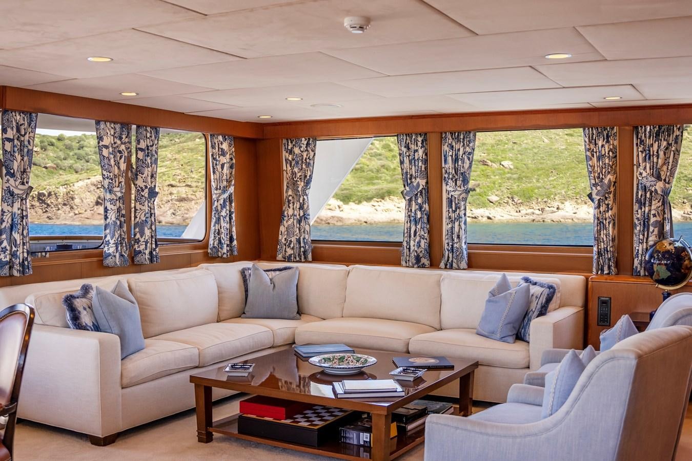 a living room with a large window aboard SEA FALCON II Yacht for Sale