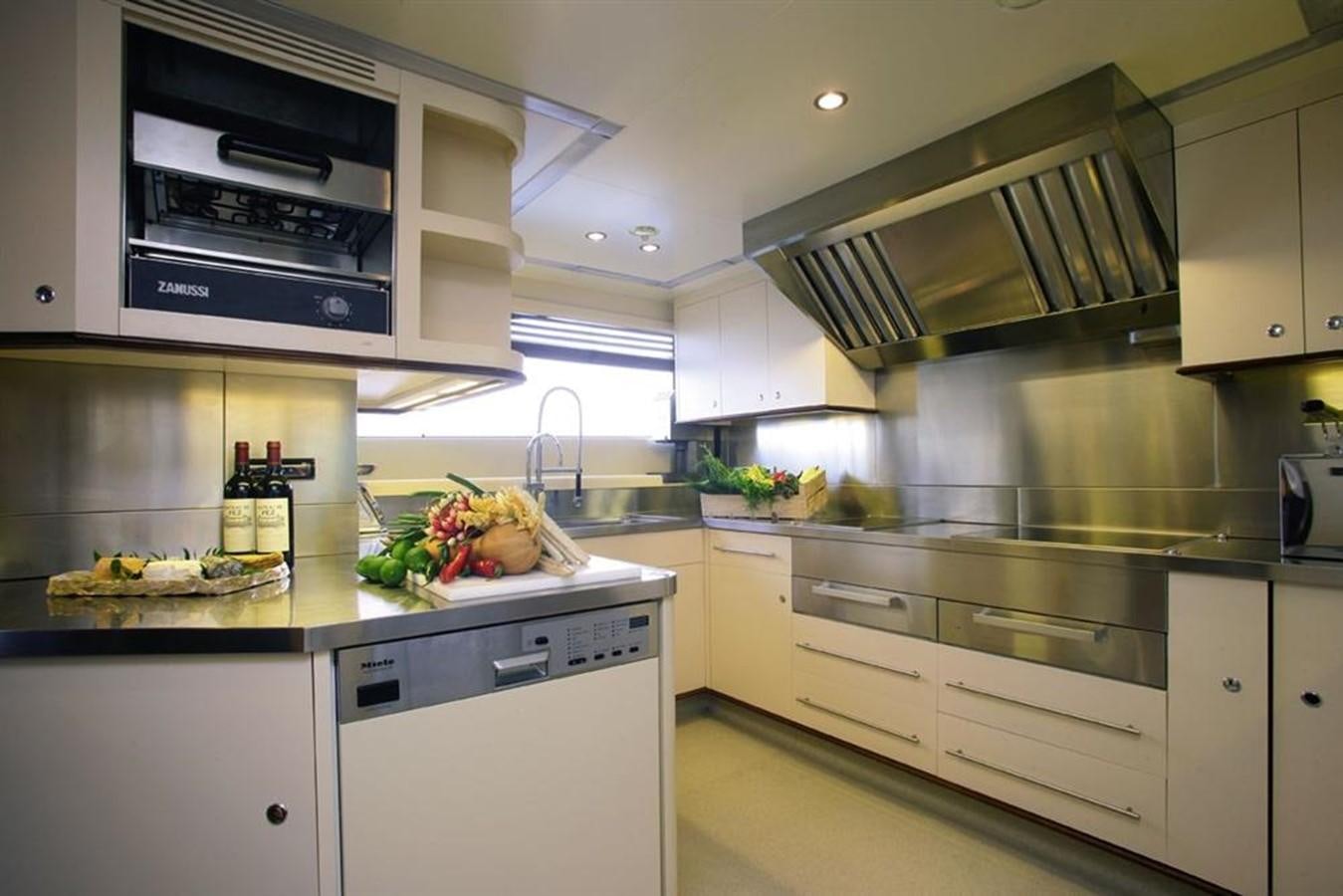 a kitchen with white cabinets aboard SEASCAPE V Yacht for Sale