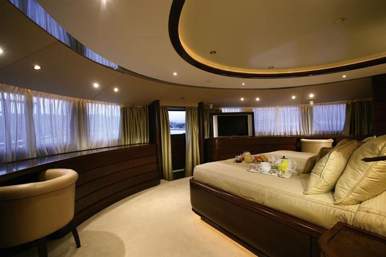 a large bedroom with a bed and a large window aboard SEASCAPE V Yacht for Sale