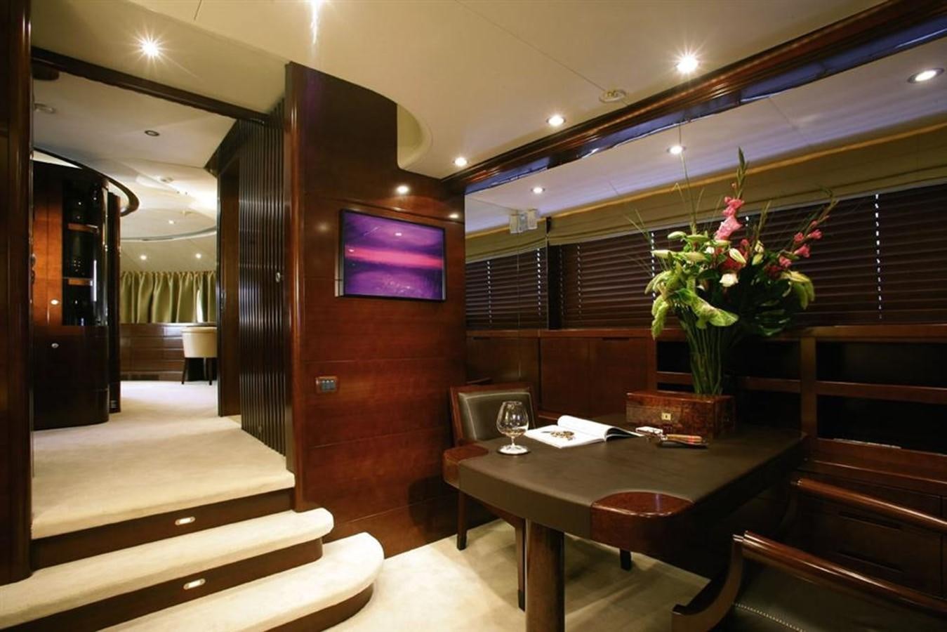 a room with a table and chairs aboard SEASCAPE V Yacht for Sale