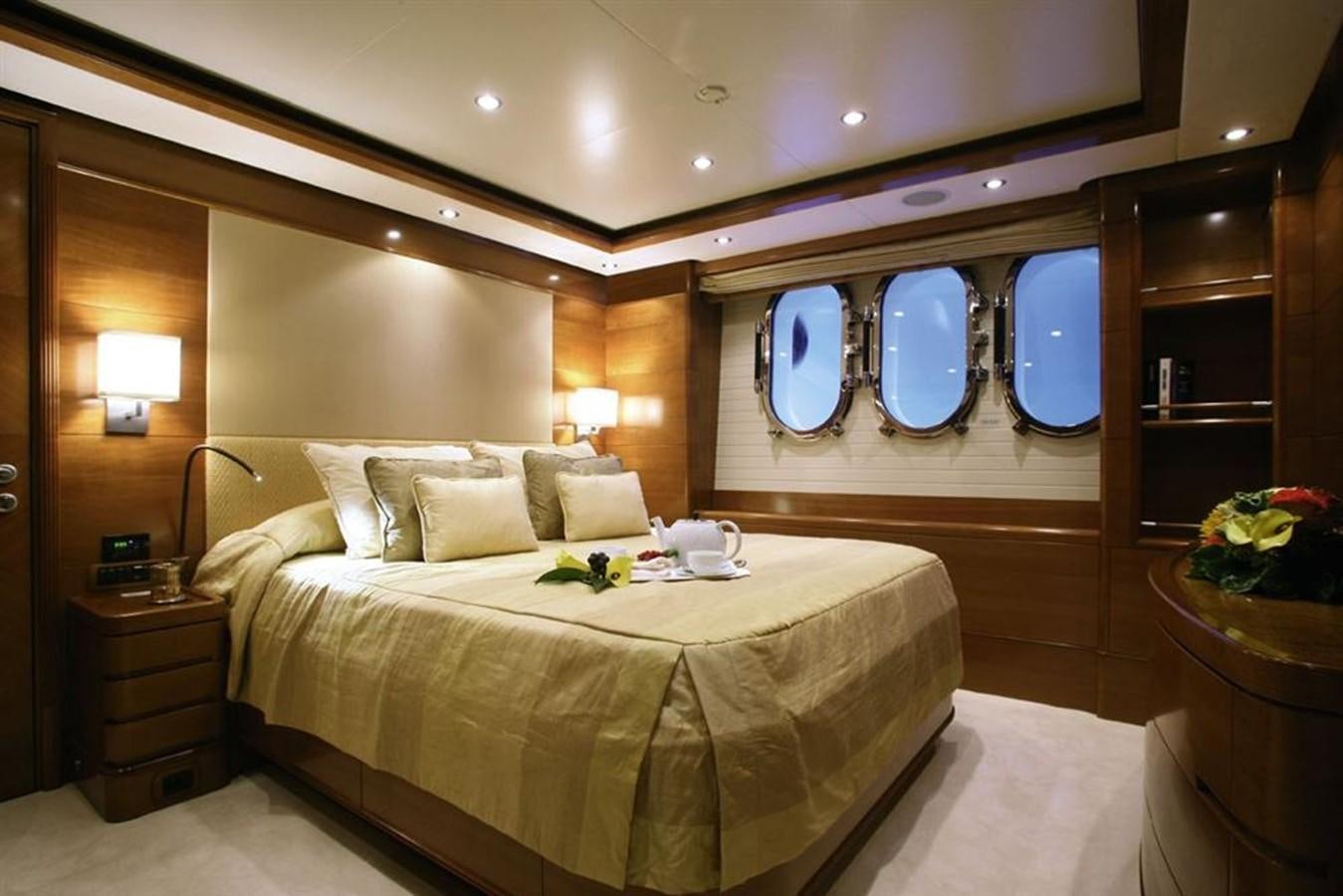 a large bedroom with a large mirror aboard SEASCAPE V Yacht for Sale