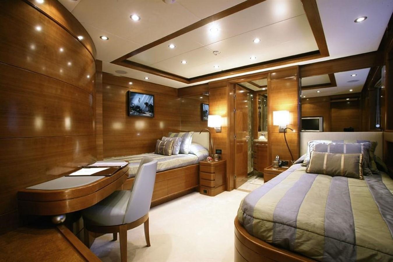 a room with a bed and a table aboard SEASCAPE V Yacht for Sale
