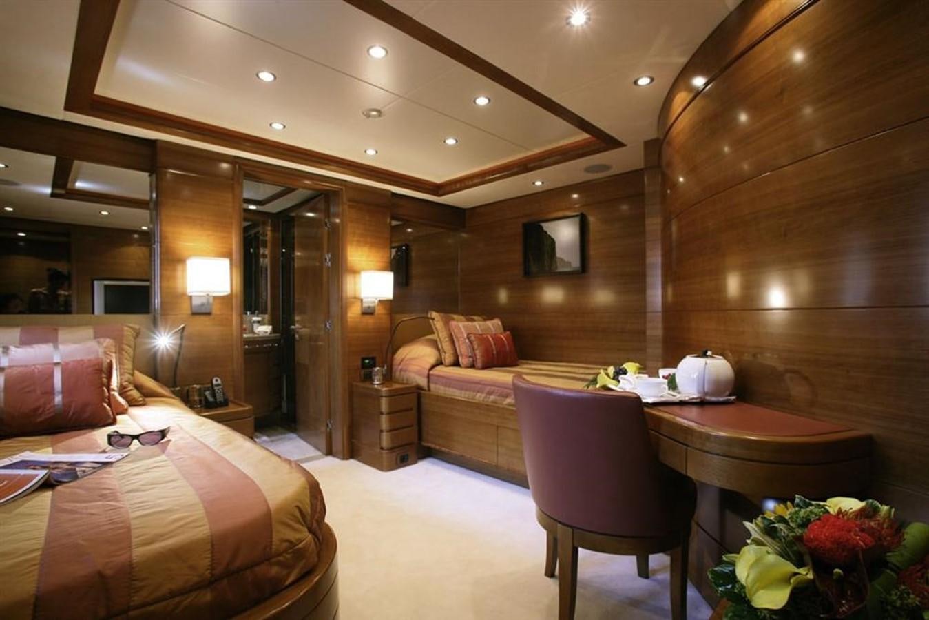 a hotel room with a bed and a table aboard SEASCAPE V Yacht for Sale