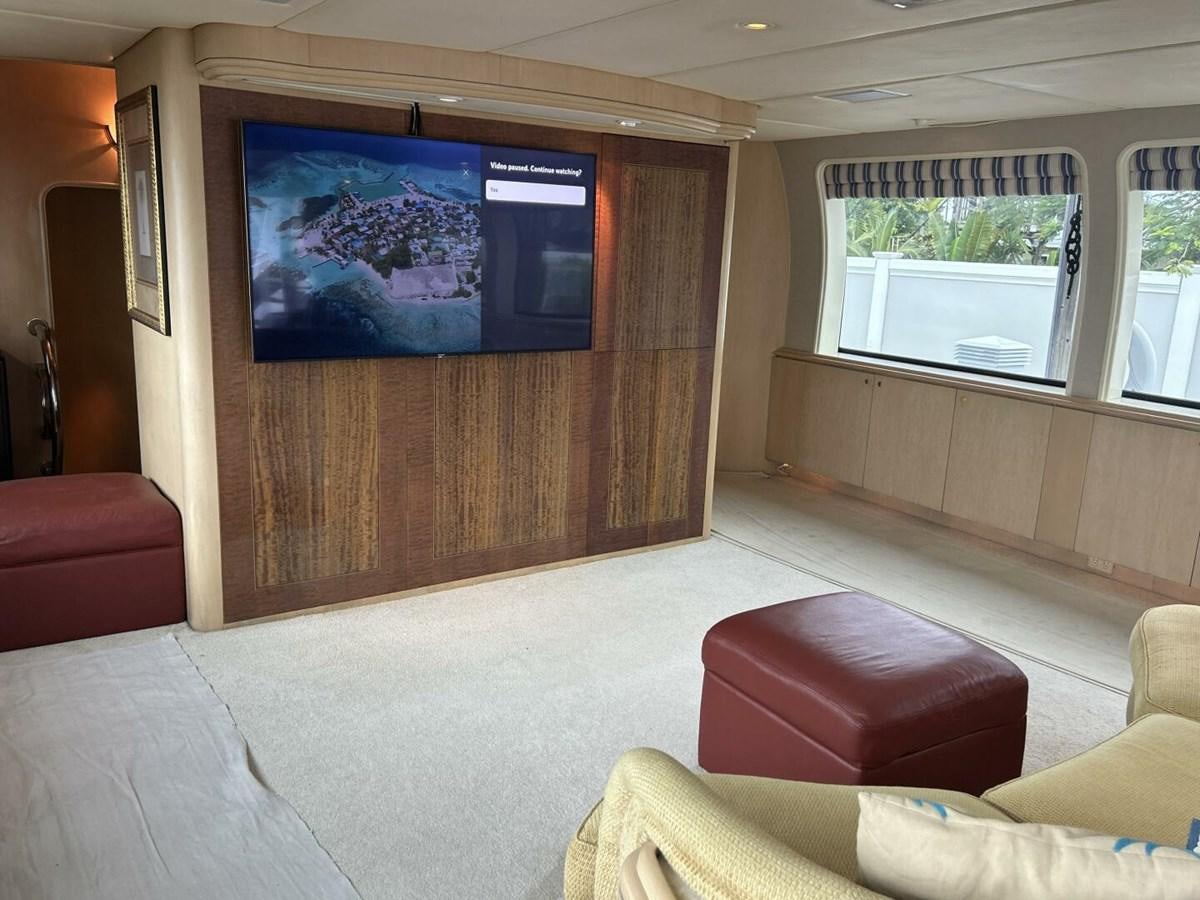 a room with a tv and couches aboard MARGAUX Yacht for Sale