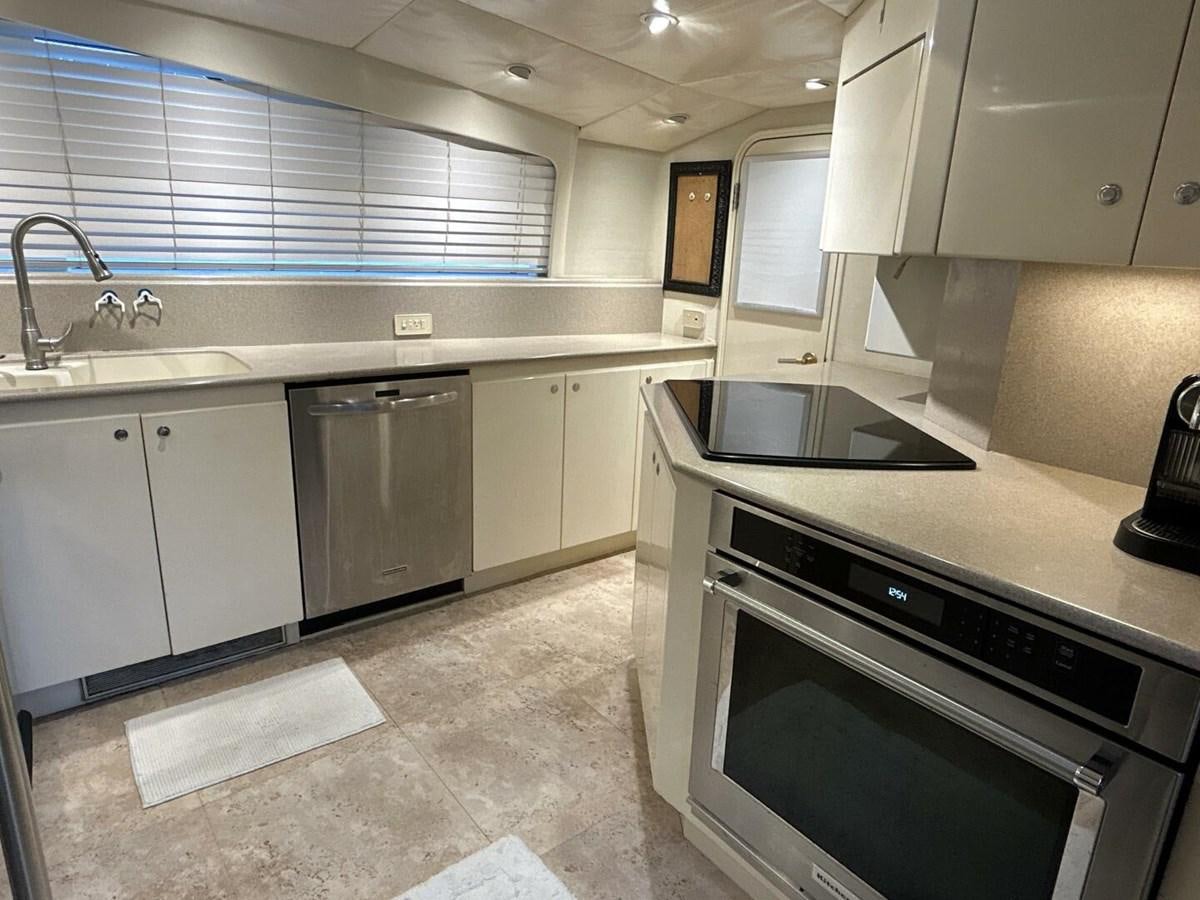a kitchen with white cabinets aboard MARGAUX Yacht for Sale