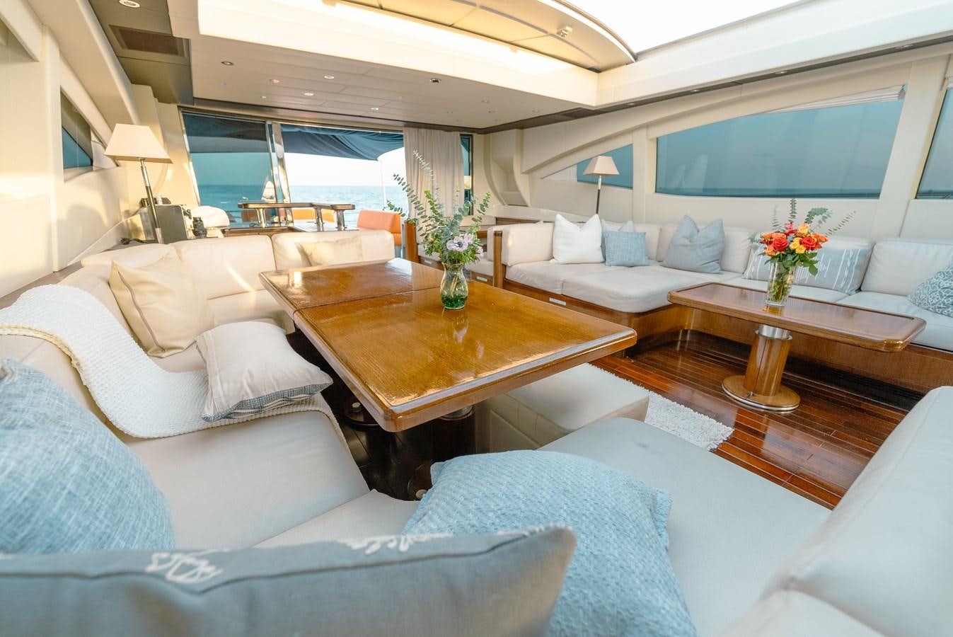 a living room with a table and couches aboard SCRATCH Yacht for Sale