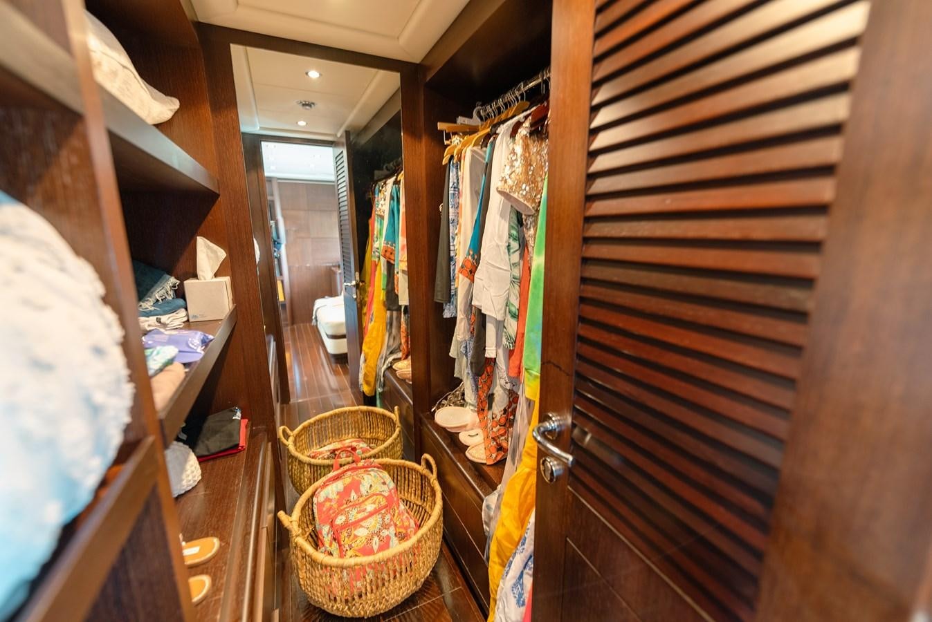 a room with a closet full of clothes and a basket aboard SCRATCH Yacht for Sale