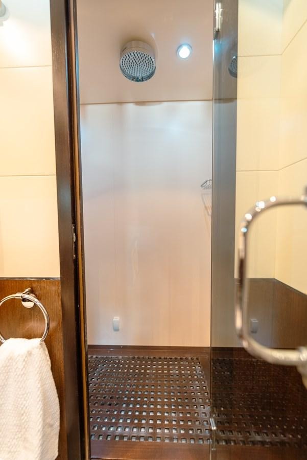 a bathroom with a urinal and a tile floor aboard SCRATCH Yacht for Sale