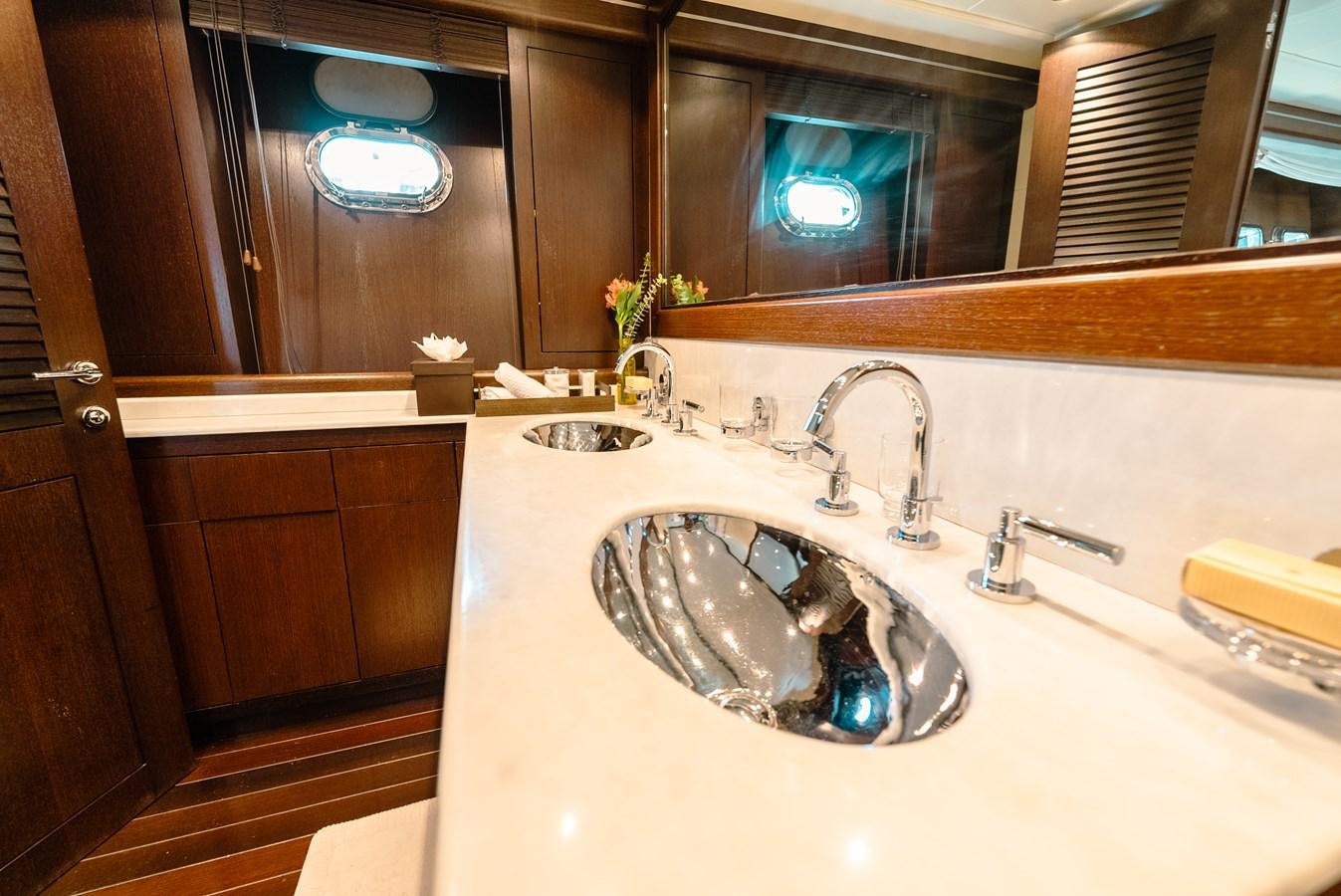 a bathroom with a sink and a mirror aboard SCRATCH Yacht for Sale
