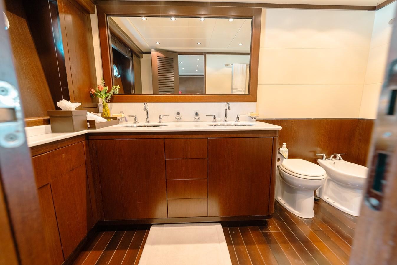a bathroom with a sink toilet and a mirror aboard SCRATCH Yacht for Sale