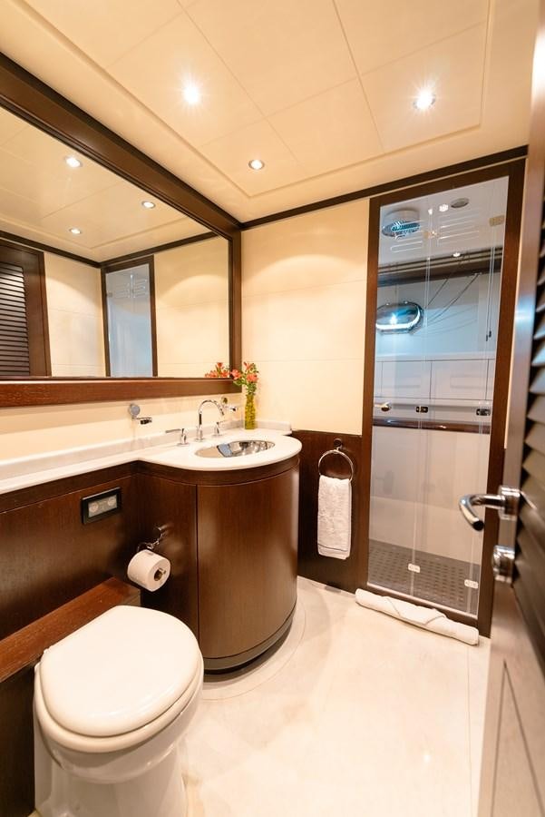 a bathroom with a glass shower door aboard SCRATCH Yacht for Sale