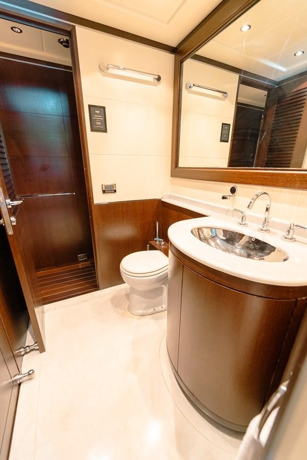 a bathroom with a toilet sink and a mirror aboard SCRATCH Yacht for Sale