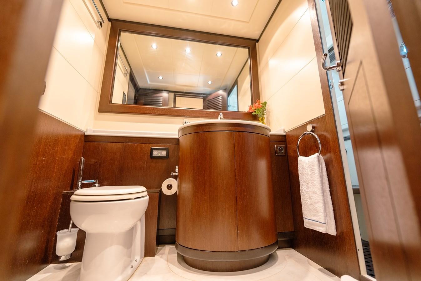 a bathroom with a toilet and a mirror aboard SCRATCH Yacht for Sale