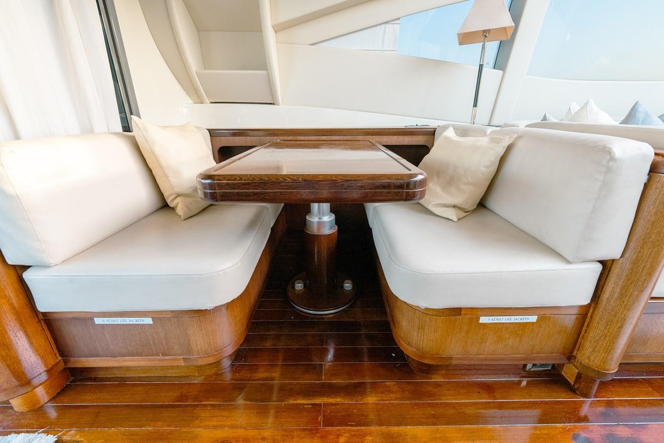 a couch and a table in a room aboard SCRATCH Yacht for Sale