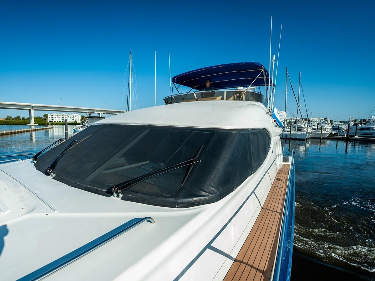 a boat docked at a pier aboard 70 Yacht for Sale