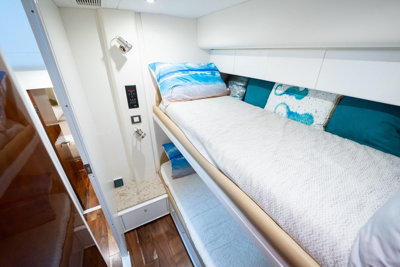 a small bed in a small room aboard 70 Yacht for Sale