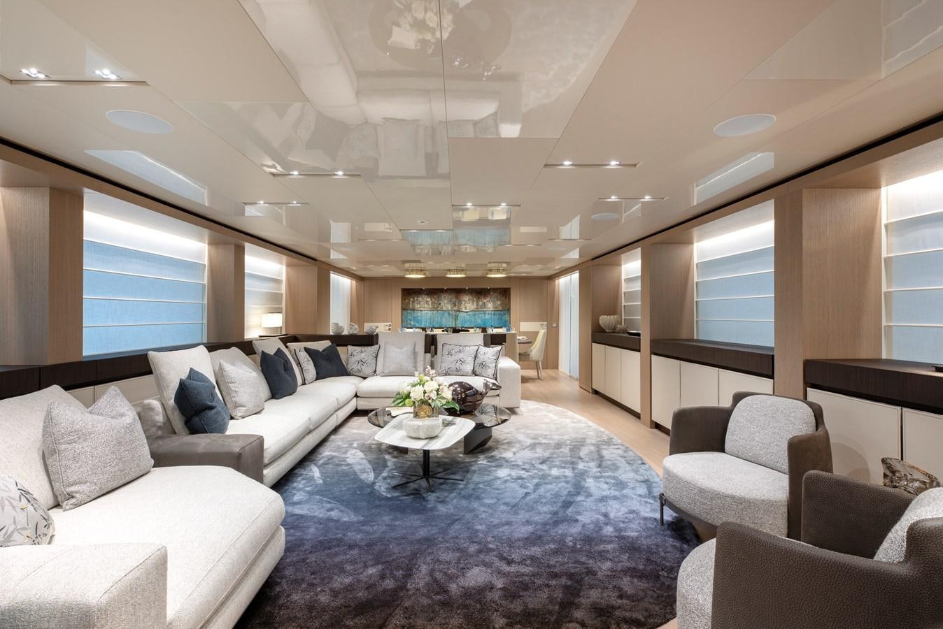 a living room with a blue rug aboard INSIEME Yacht for Sale