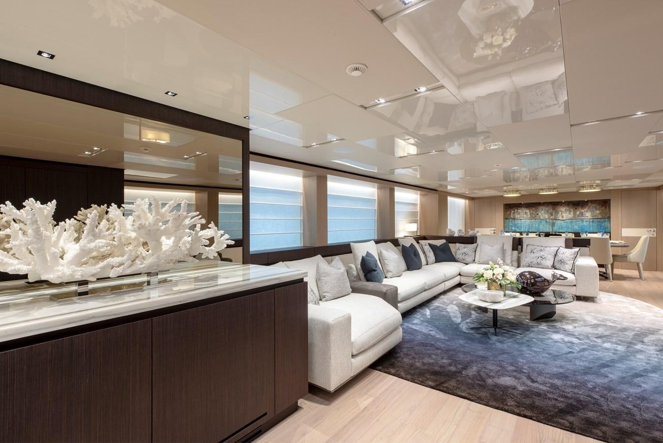 a living room with a large mirror aboard INSIEME Yacht for Sale