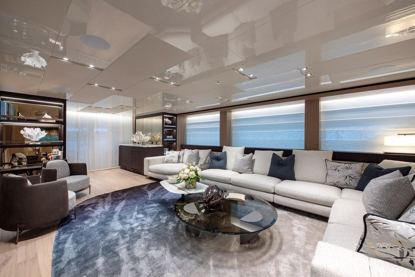 a living room with a large glass table and a large window aboard INSIEME Yacht for Sale