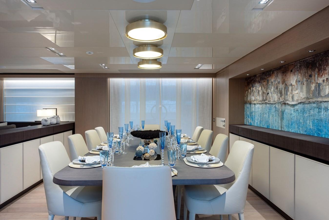a large room with a table and chairs aboard INSIEME Yacht for Sale