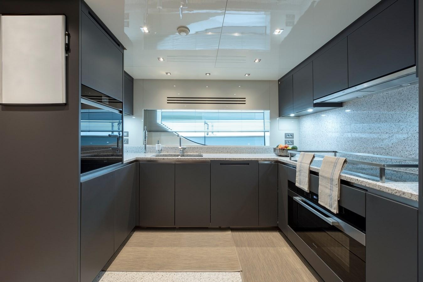 a kitchen with a large island aboard INSIEME Yacht for Sale