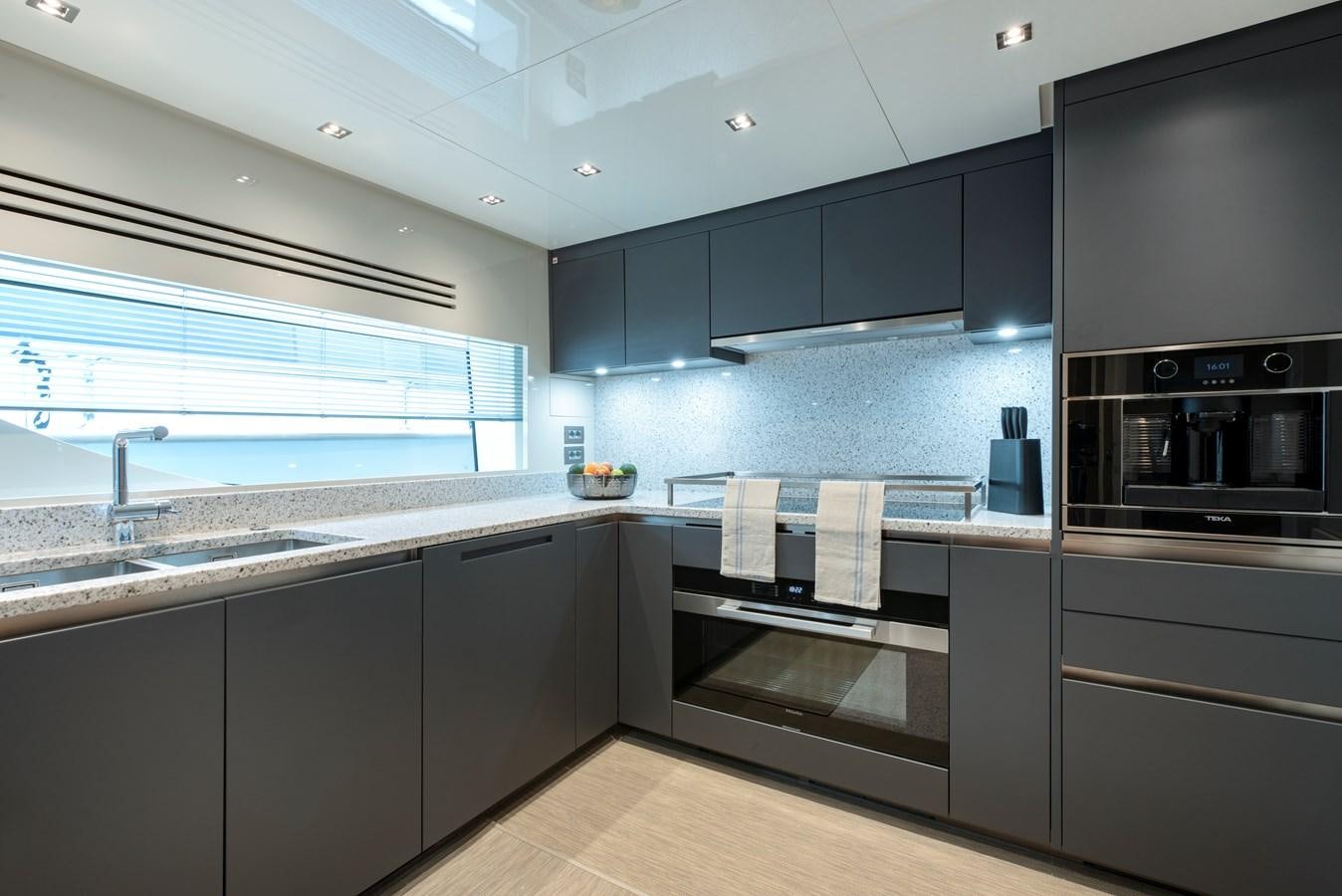 a kitchen with black cabinets aboard INSIEME Yacht for Sale