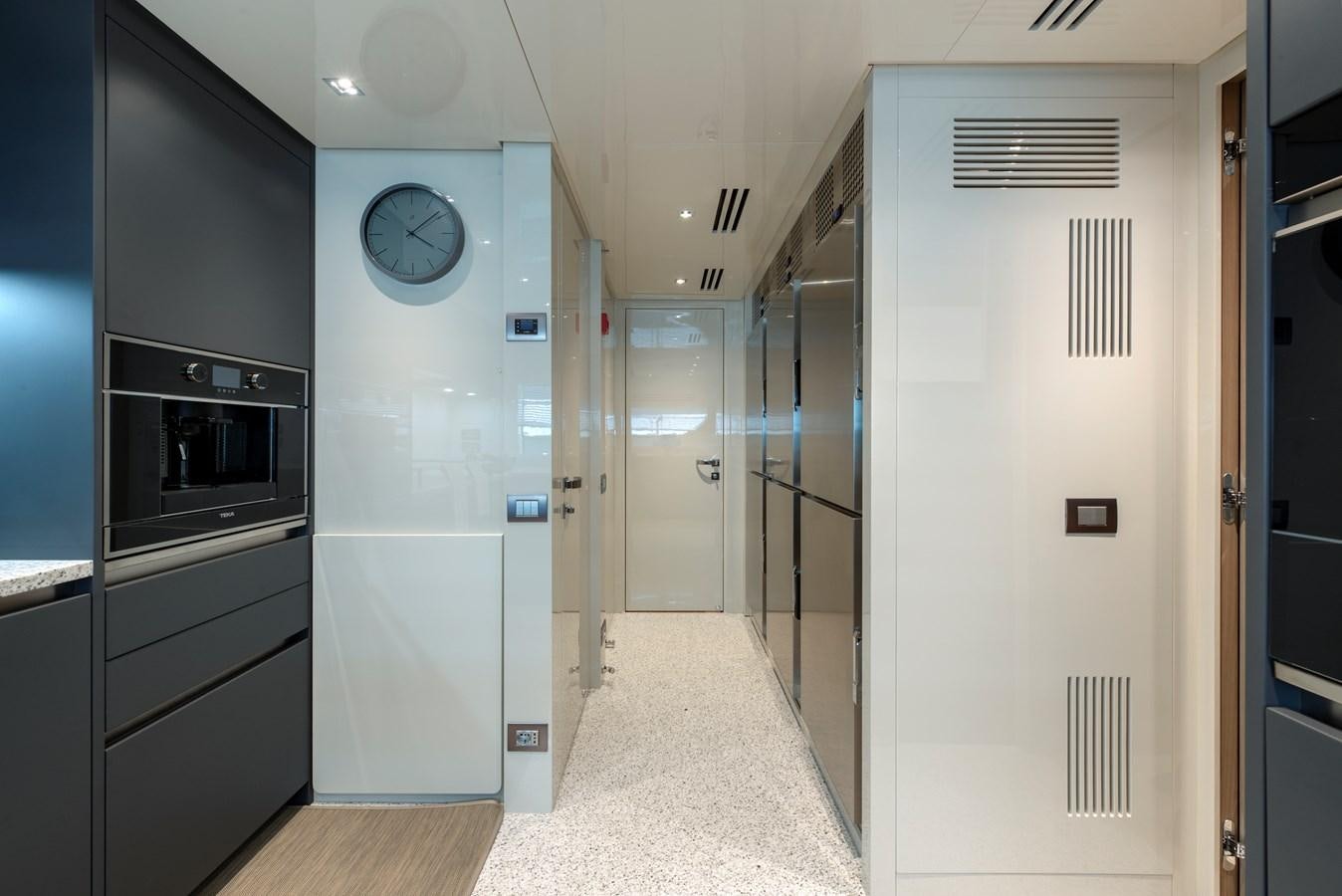 a hallway with a clock and a door aboard INSIEME Yacht for Sale