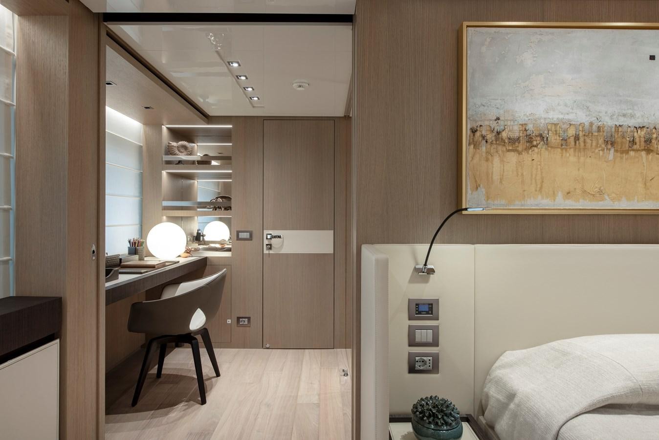a room with a bed and a desk aboard INSIEME Yacht for Sale