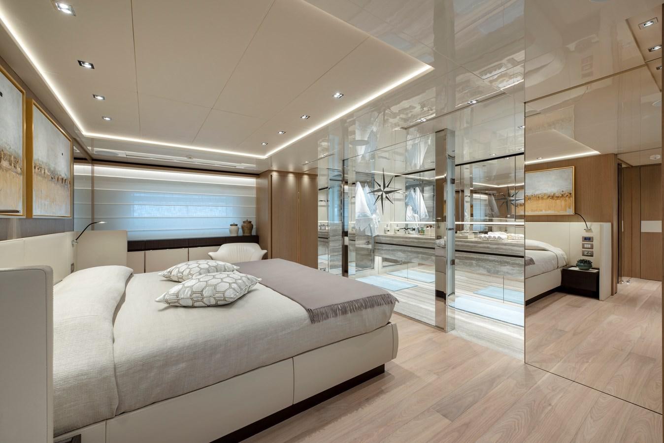 a bedroom with a bed and a large mirror aboard INSIEME Yacht for Sale