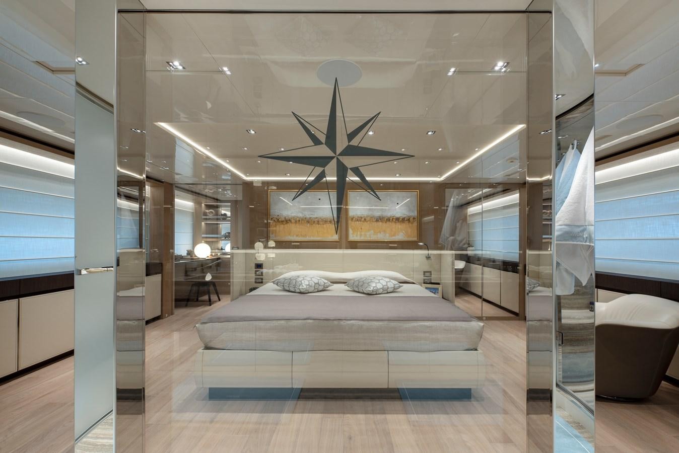 a bed with a white bed and a fan aboard INSIEME Yacht for Sale