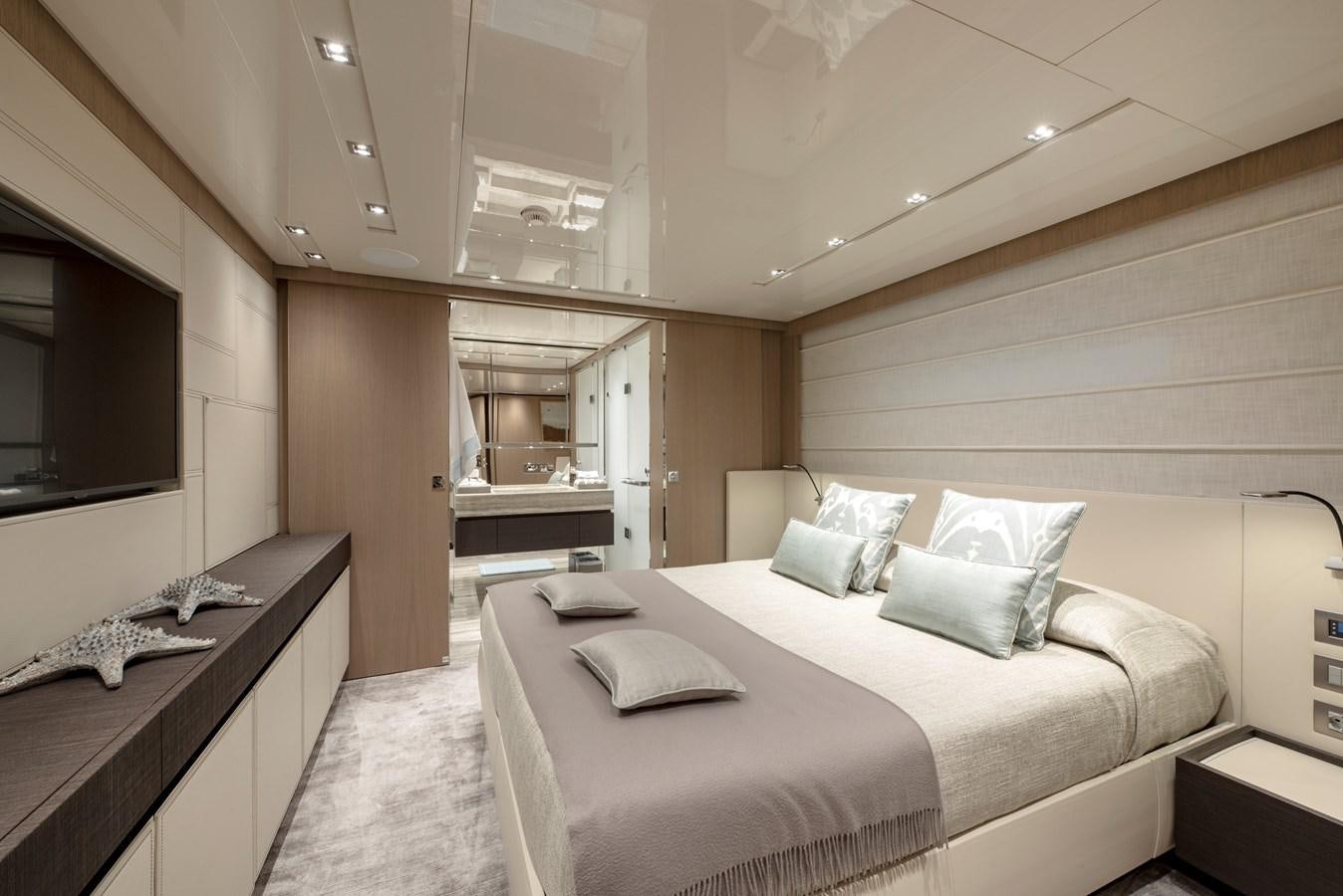 a room with a bed and a tv aboard INSIEME Yacht for Sale